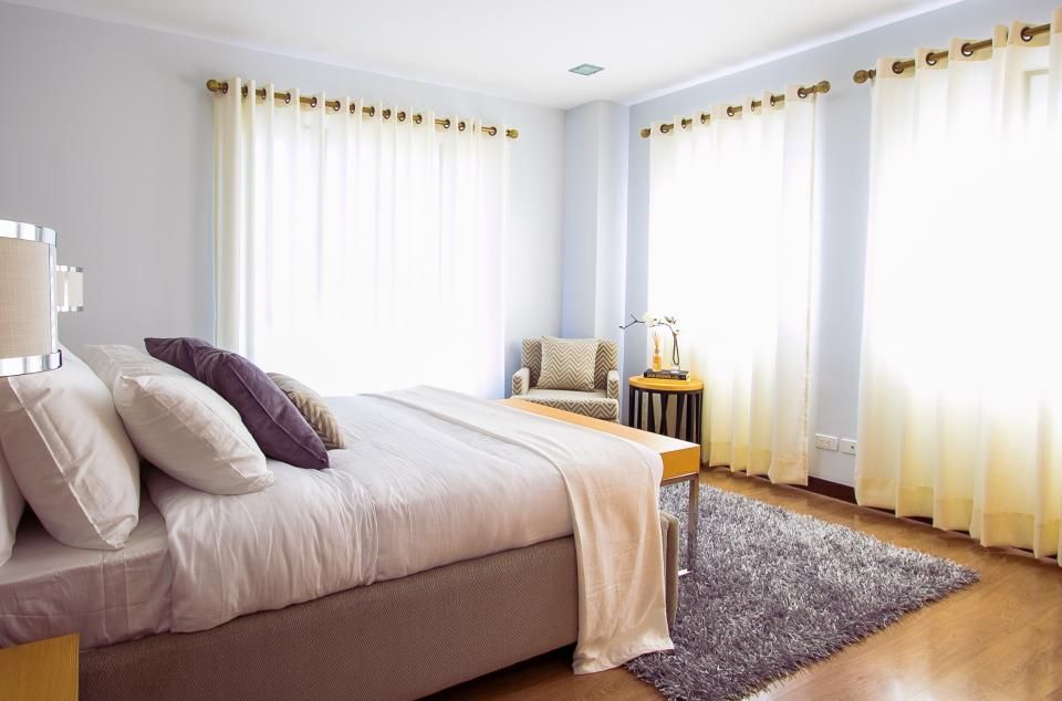 Main bedroom with a double bed and curtains