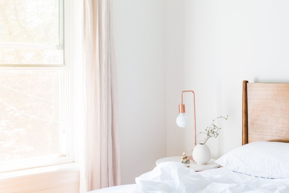 Bedroom with a bed beside a bright window