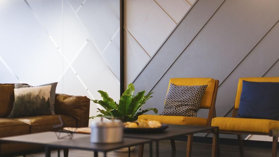 Hall with a plant and yellow chairs